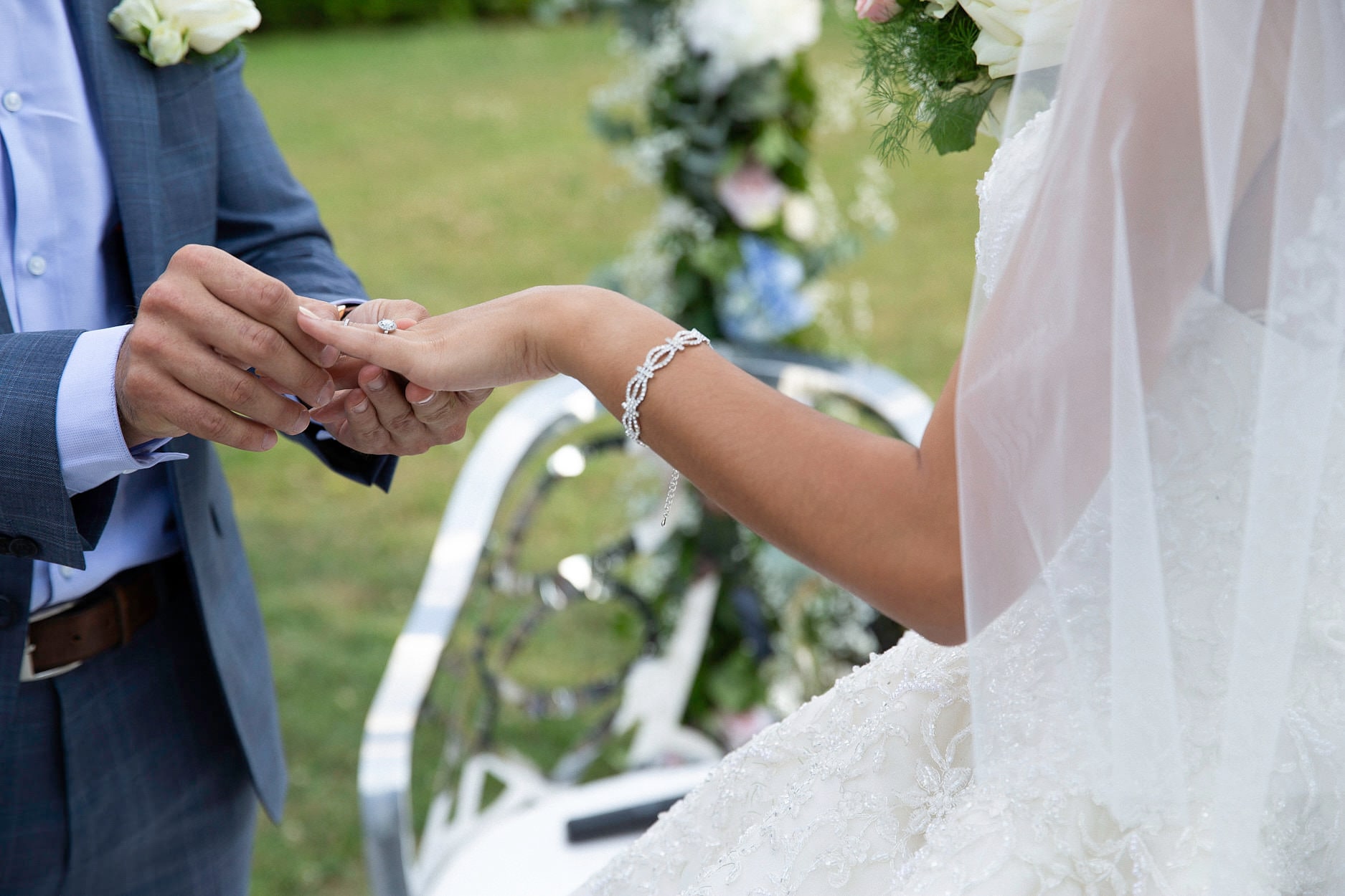 A close frame of a ring being pushed onto a finger during the vows